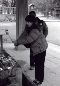 Mari makes an offering with Hideki looking on